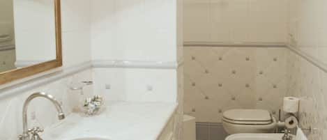 A bathroom with a sink, mirror, and toilet.
