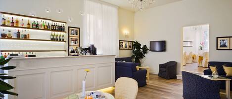A modern living room with a bar area, comfortable seating, and a television.
