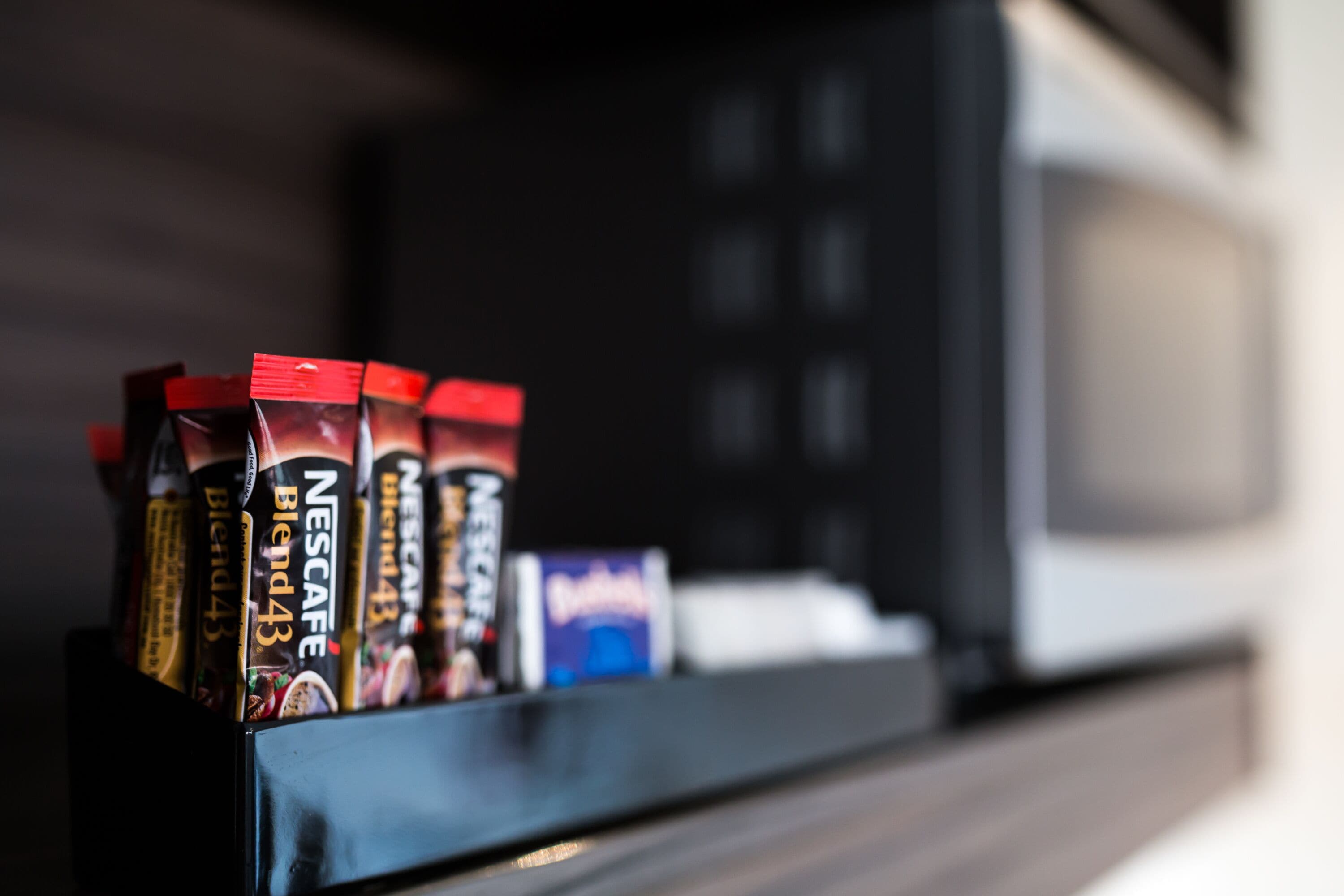 A coffee machine with multiple coffee pods on a countertop.
