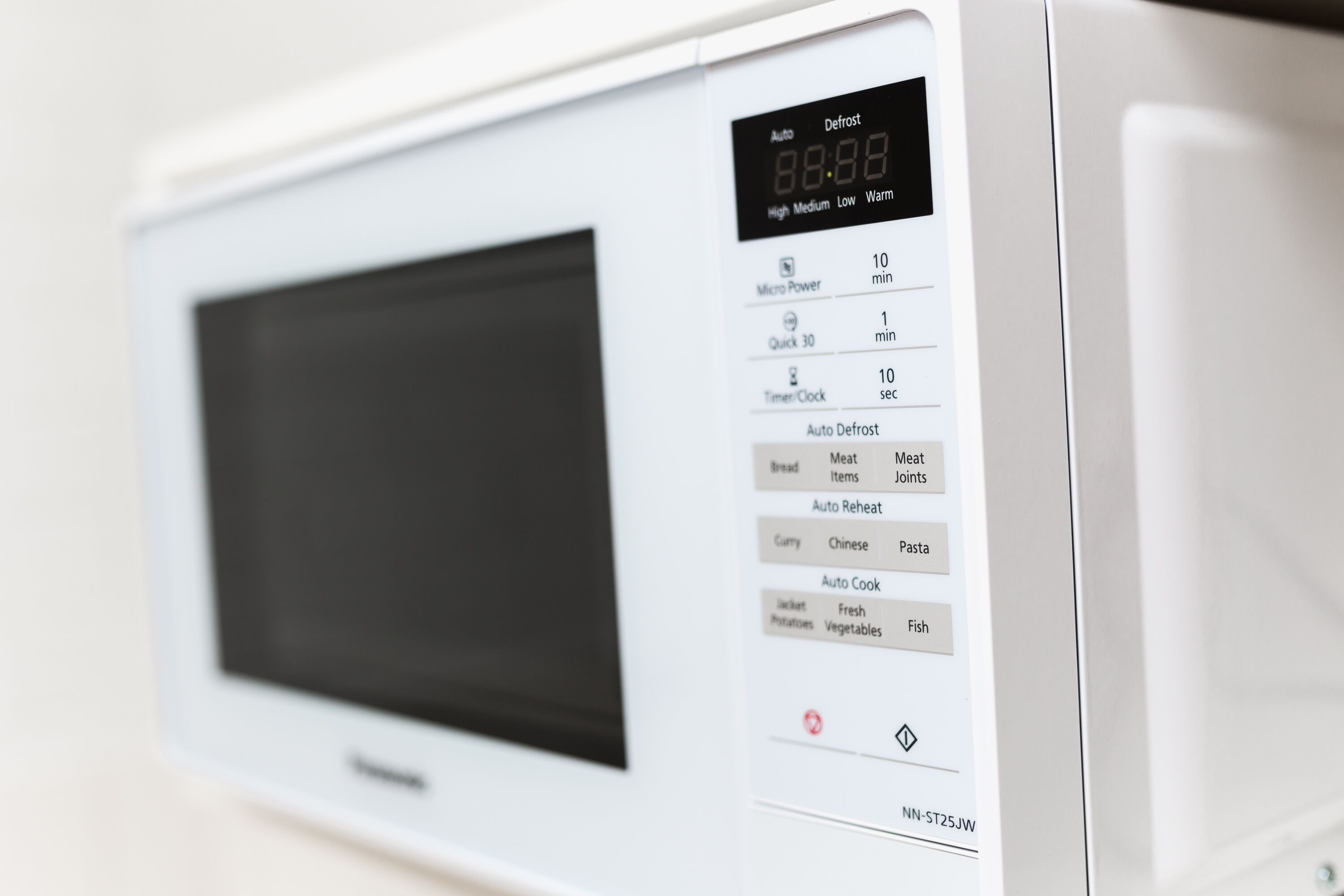 A microwave with a digital display and various settings options.