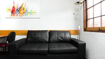 Standard Two Bedroom Apartment (Multi-Level) | Living area | Flat-screen TV