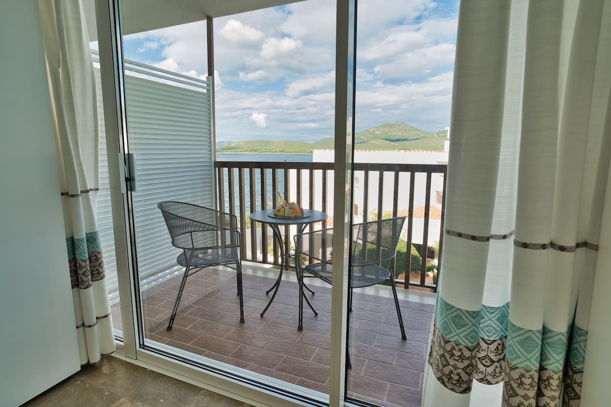 classic double room, partial sea view | 1 bedroom, premium bedding, minibar, in-room safe