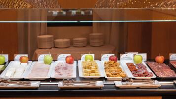 A buffet with various food items and a sign with letters 'HCH'.