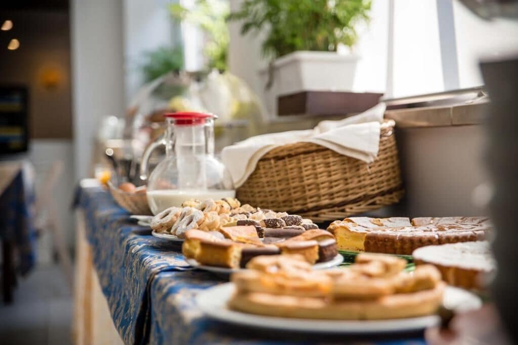 A buffet table with various pastries and desserts.