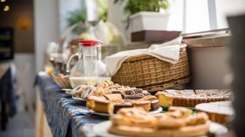A buffet table with various pastries and desserts.