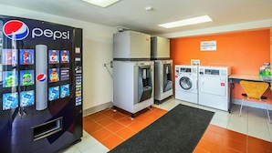 A room with a Pepsi vending machine, ice cubes dispenser, and a washing machine. - Ocean Inn South Padre Island (South Padre Island)
