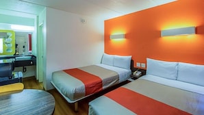 A hotel room with two beds, a desk, and a chair. - Ocean Inn South Padre Island (South Padre Island)