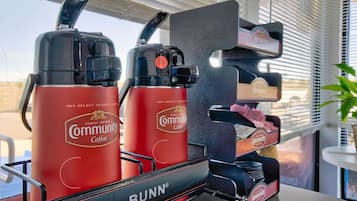 A coffee machine branded with 'Community Coffee' and 'Bunn' in a commercial setting.