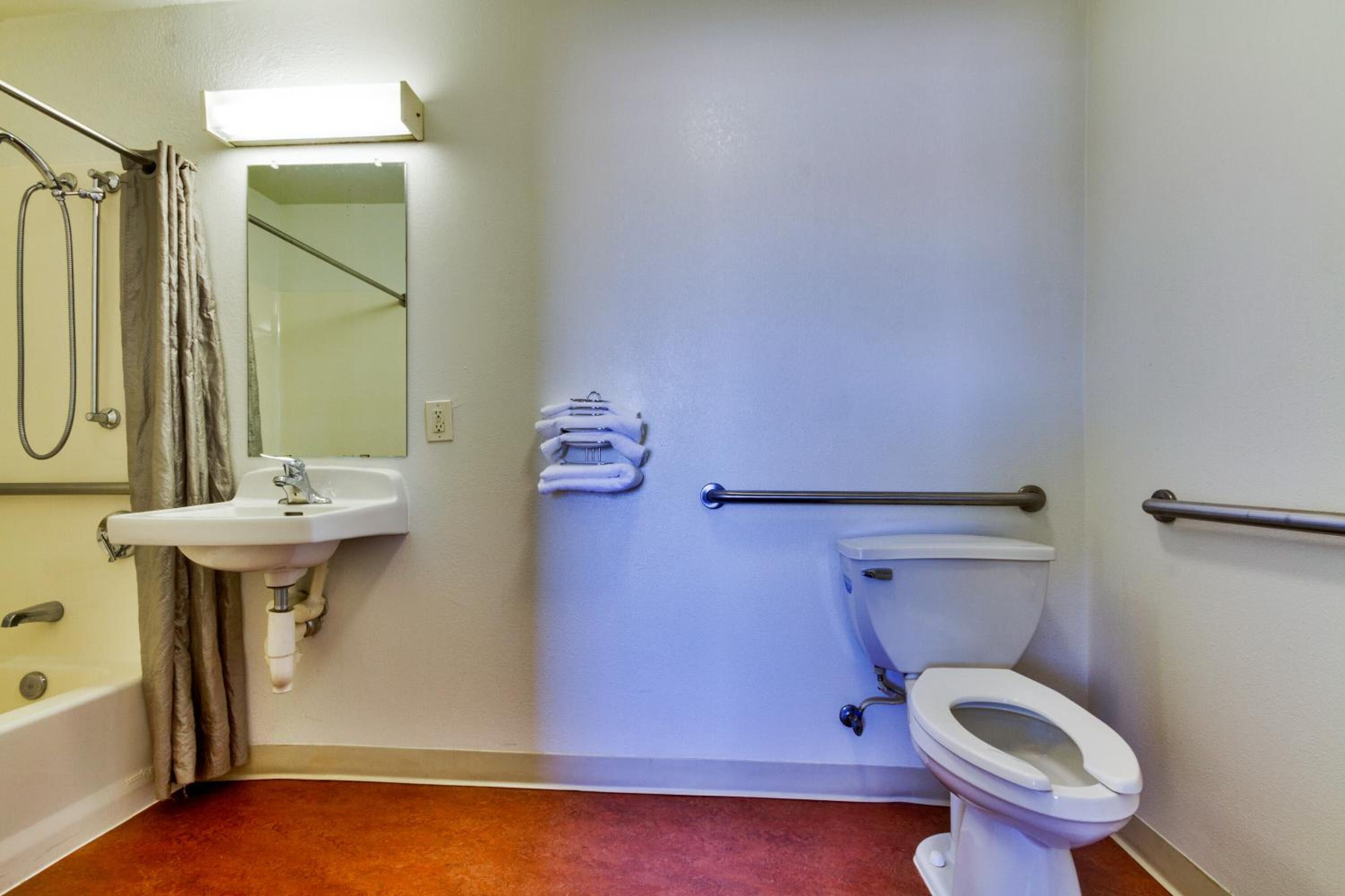 A bathroom with a sink, toilet, and bathtub.