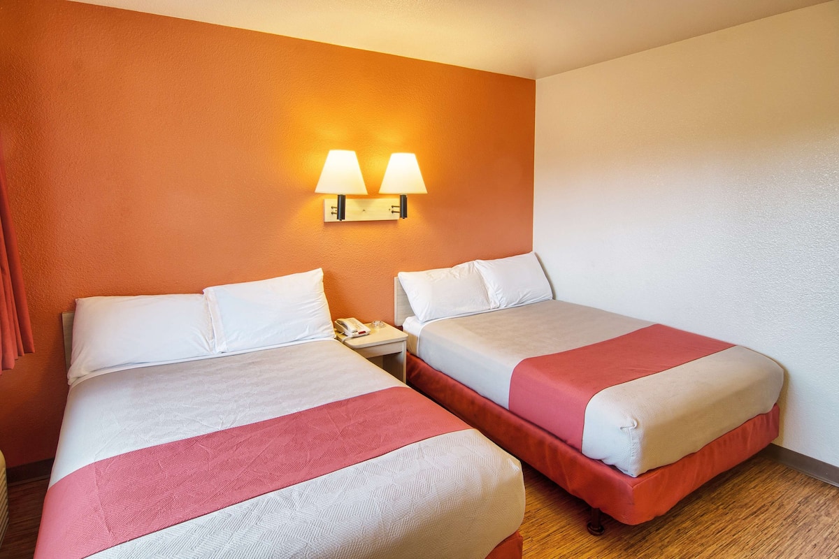 Laptop workspace, bed sheets