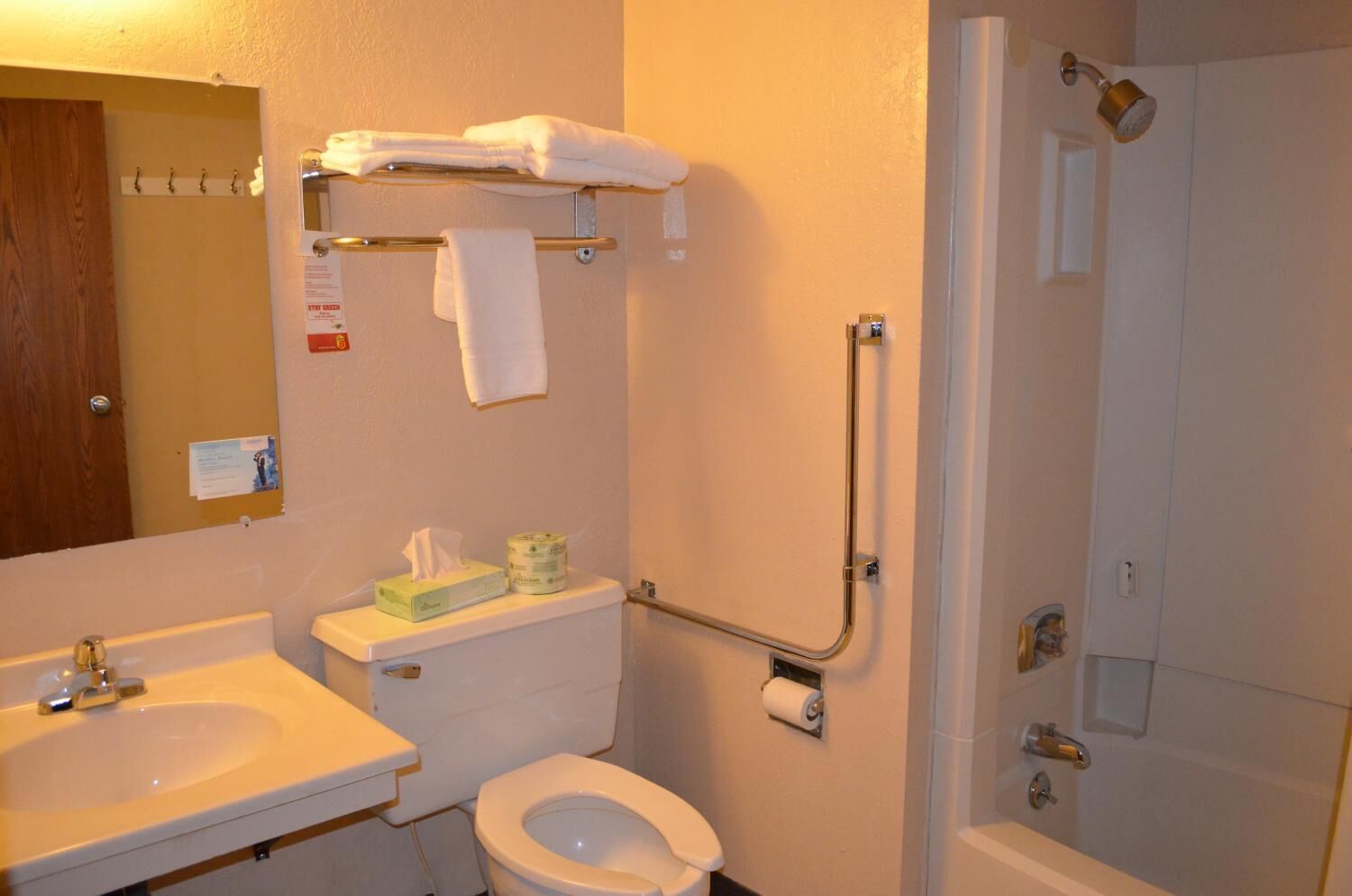A bathroom with a toilet, sink, and shower.