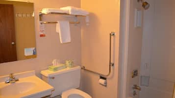 A bathroom with a toilet, sink, and shower.