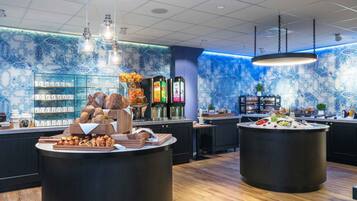 A modern breakfast buffet with a variety of breads, pastries, and beverages.