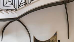 A staircase with a mural depicting a historical scene. - Domus Sessoriana (Rome)