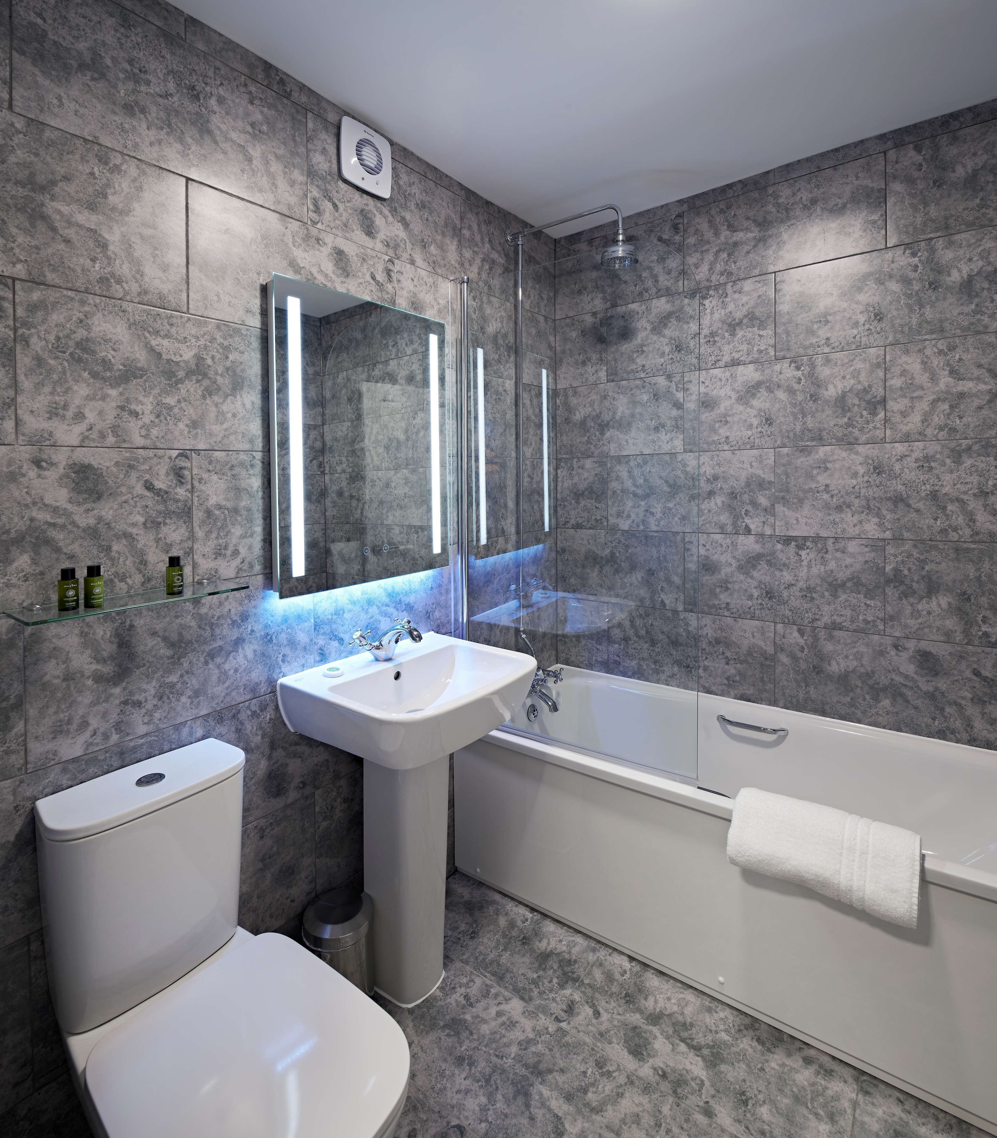 combined shower/bathtub, designer toiletries, hair dryer, towels