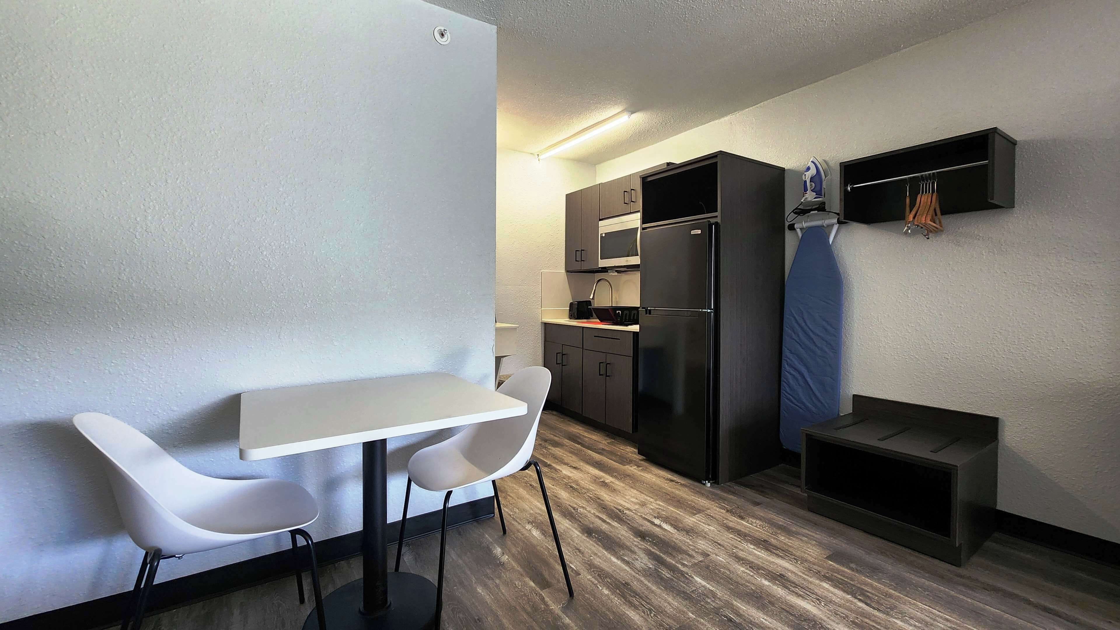 Desk, laptop workspace, blackout drapes, iron/ironing board