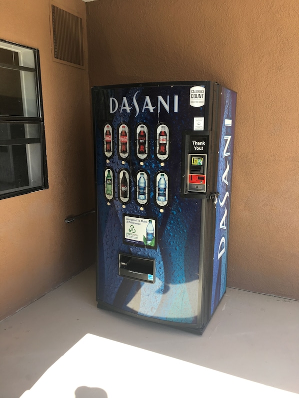 A Dasani water vending machine with multiple beverage options. - Kingman Inn Route 66 I-40 (Kingman)