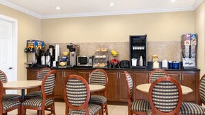 A hotel kitchen with a buffet setup, including a coffee station and various food items. - Kingman Inn Route 66 I-40 (Kingman)