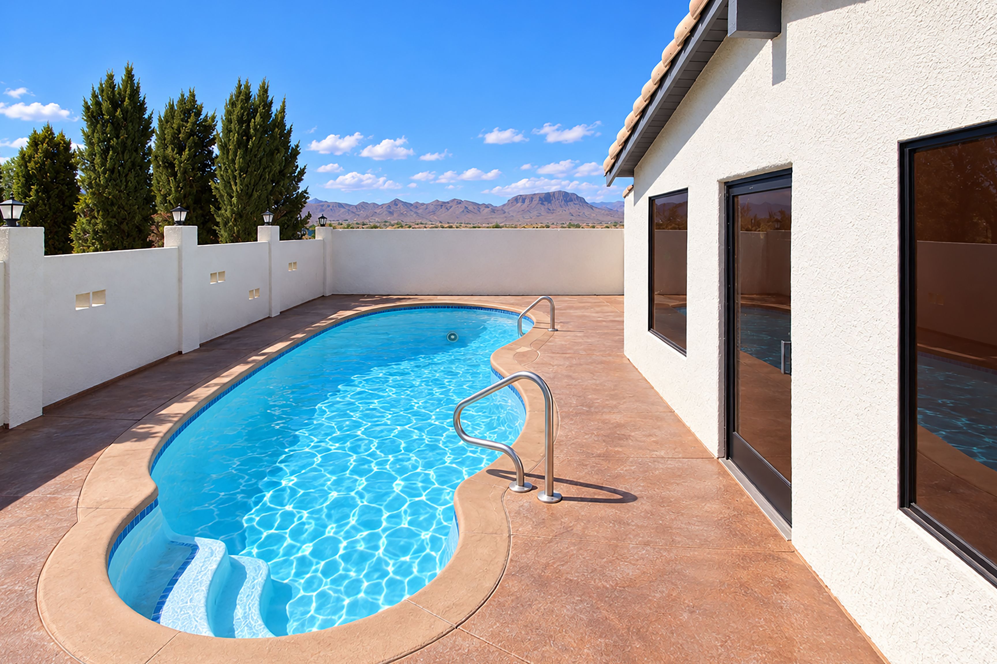 A swimming pool with a view of mountains in the background.