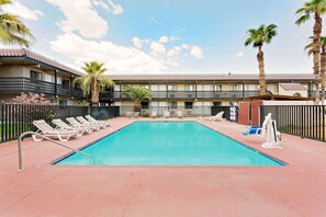 Outdoor pool, open 11 AM to 9 PM, pool loungers