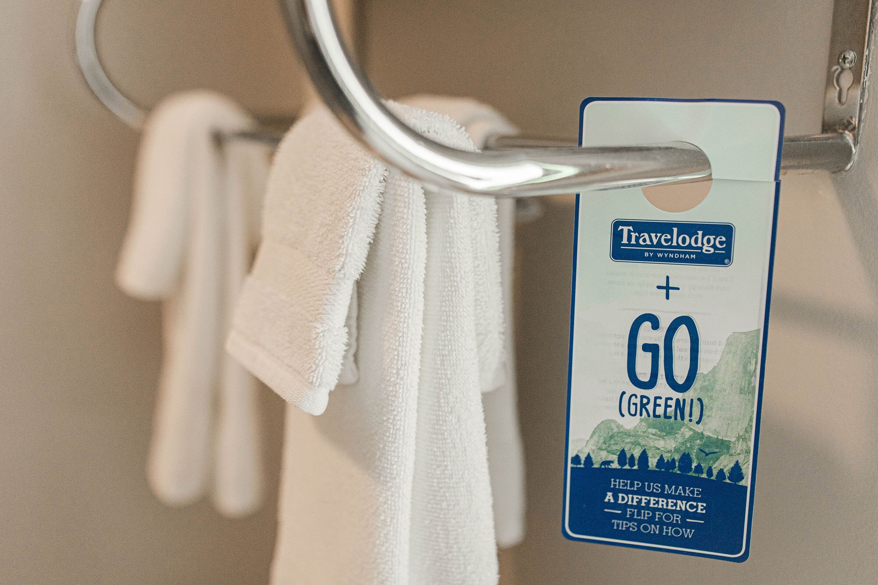 A travel card with the text "Travelodge by Wyndham" and "GO (GREEN!)" indicating an eco-friendly initiative.