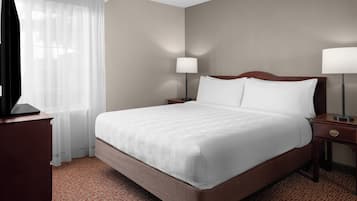 Premium bedding, desk, laptop workspace, blackout curtains