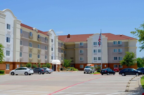 A multi-story hotel with a parking lot.