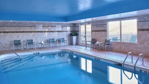 A swimming pool with clear water, surrounded by chairs and a 'No Diving' sign. - Fairfield by Marriott Kalamazoo West (Kalamazoo)