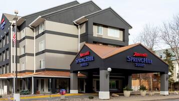 A Marriott SpringHill Suites hotel with a modern design, featuring a covered entrance and multiple floors.