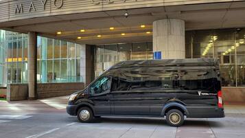 A black van parked in front of the Mayo Clinic building.