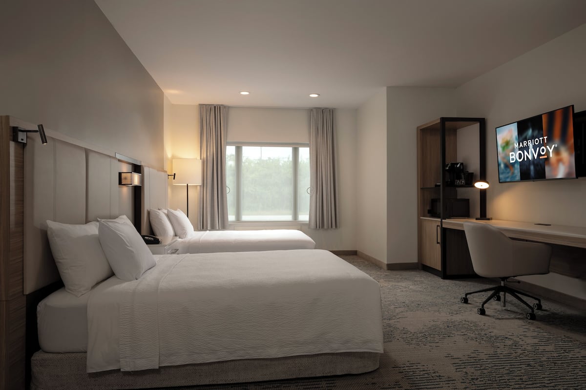 Premium bedding, desk, laptop workspace, blackout curtains