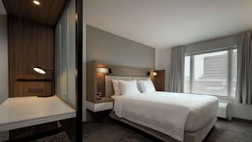 Premium bedding, desk, laptop workspace, blackout drapes