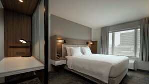 A modern hotel room with a large bed, bedside tables, a desk, and a window with curtains. - Springhill Suites By Marriott Houston Brookhollow (Houston)