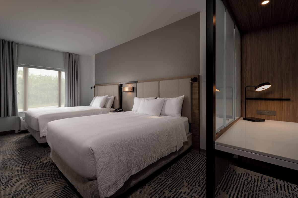 Premium bedding, desk, laptop workspace, blackout curtains