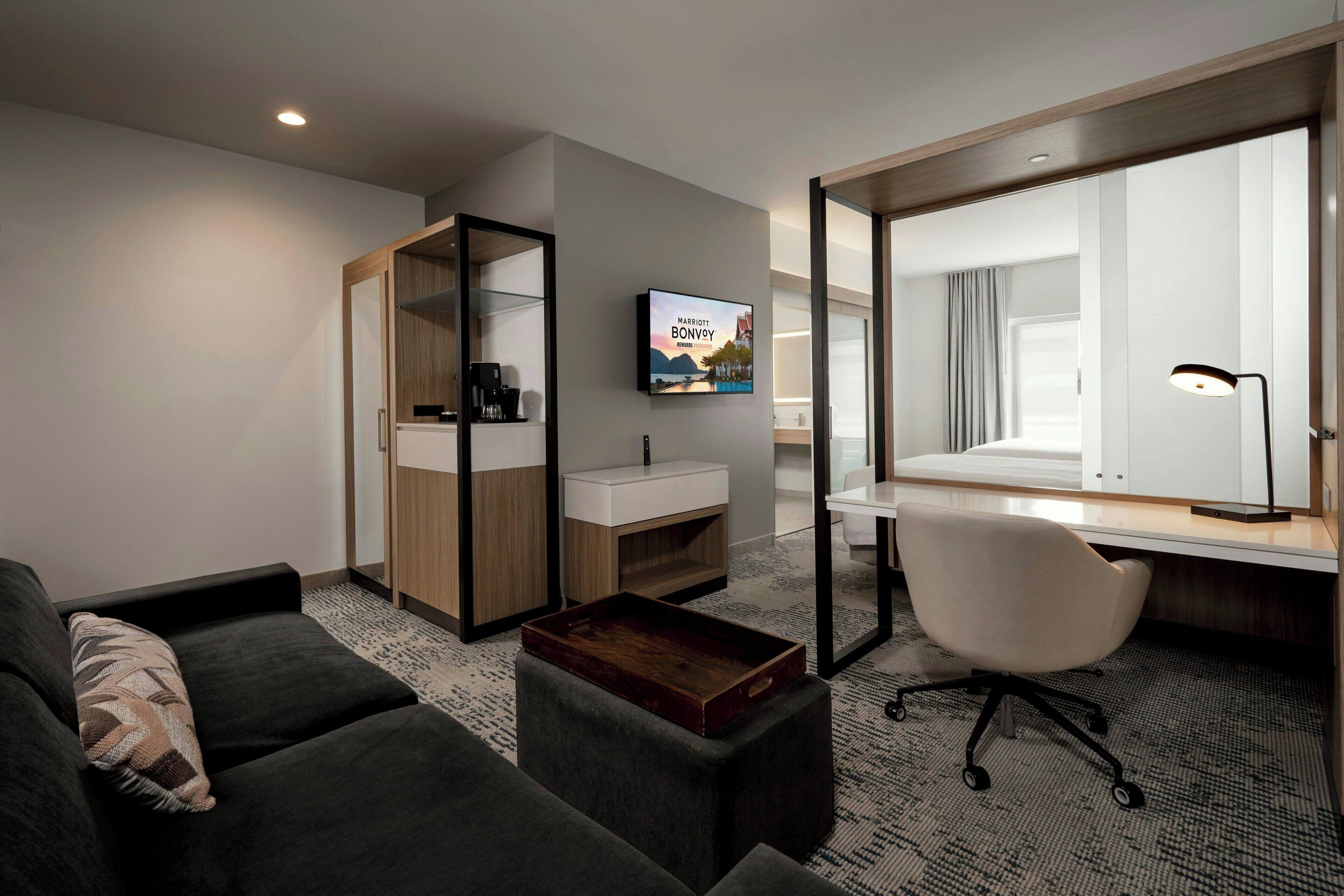 suite, multiple beds | living area | tv