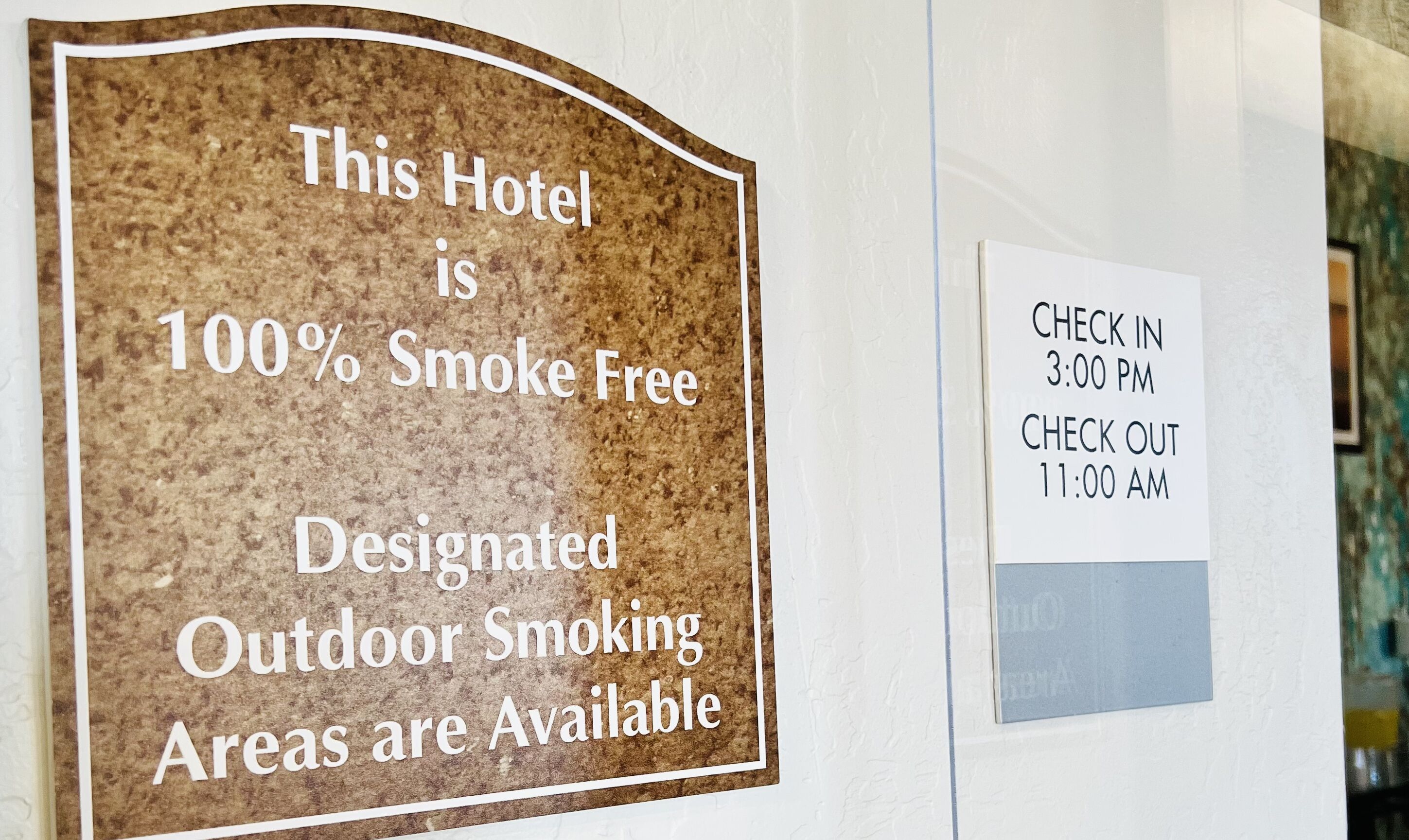 A sign indicating the hotel is 100% smoke-free with designated outdoor smoking areas.