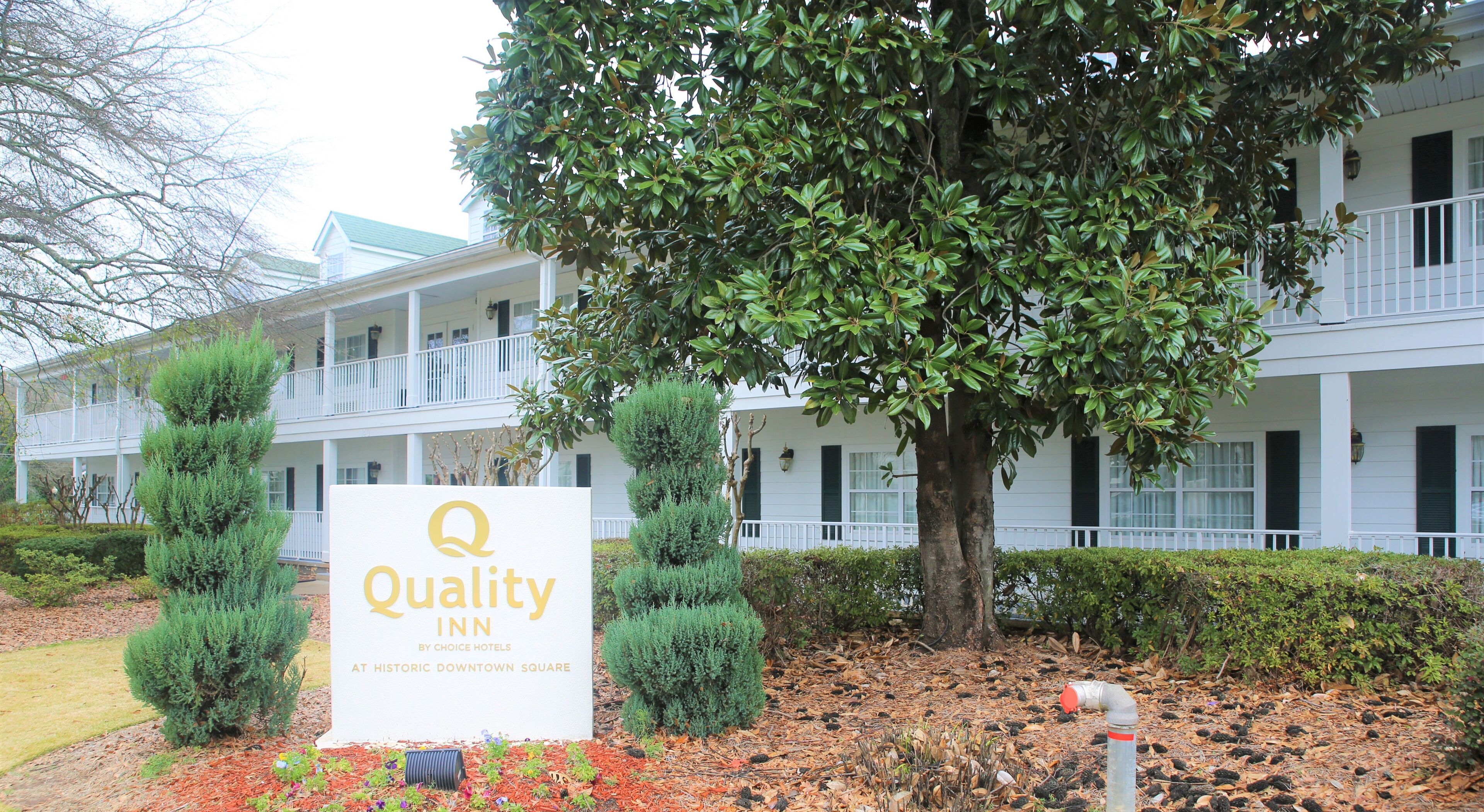 A sign for the Quality Inn by Choice Hotels at Historic Downtown Square.