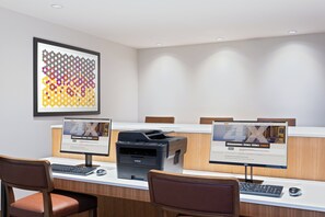 A conference room with a long table, two monitors, a printer, and a framed artwork on the wall. - Holiday Inn Express Ft. Lauderdale Cruise-Airport by IHG (Fort Lauderdale)