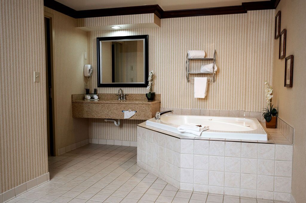 superior suite, 1 king bed, non smoking (one-bedroom) | bathroom | rainfall showerhead, free toiletries, hair dryer, towels