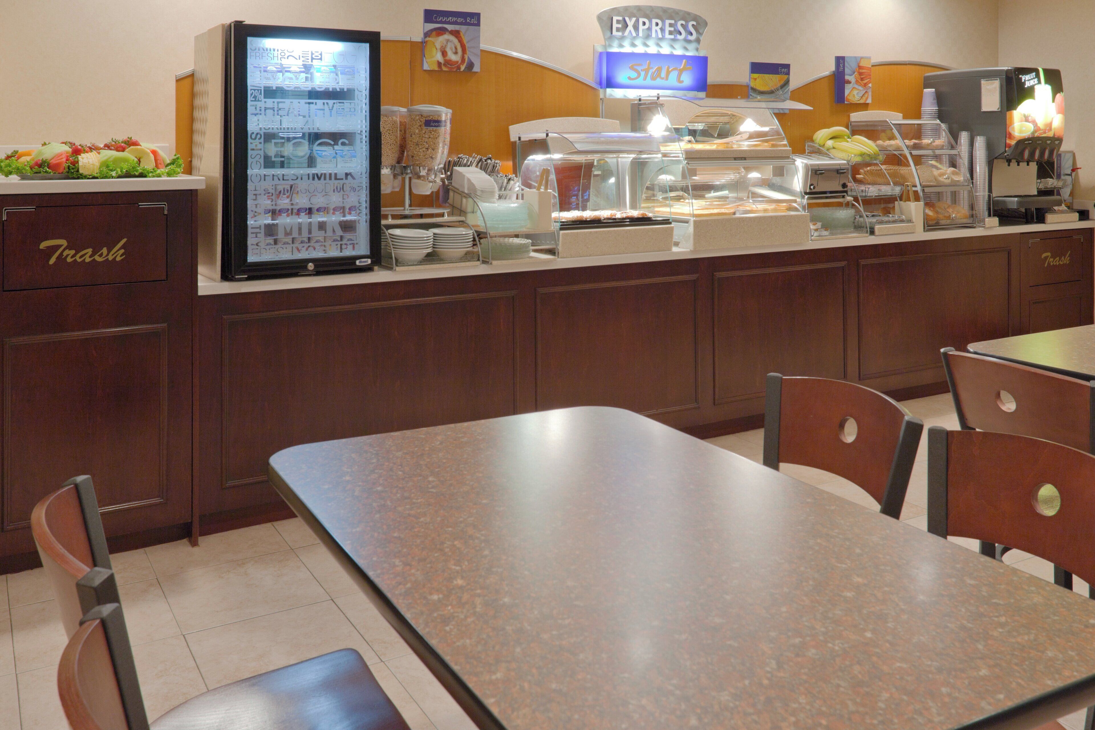 A buffet area with a refrigerated display case, a coffee machine, and a sign indicating the start of the express line.