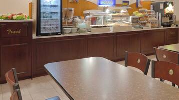 A buffet area with a refrigerated display case, a coffee machine, and a sign indicating the start of the express line.