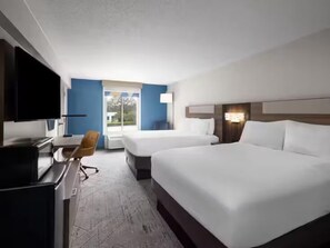 A hotel room with two beds, a desk with a chair, a television, and a window with a view of the outdoors. - Holiday Inn Express Greenville by IHG (Greenville)