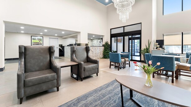 A spacious lobby with leather armchairs, a chandelier, and a reception desk. - Quality Inn Sandersville (Sandersville)