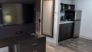 A modern kitchen with a built-in refrigerator, a coffee maker, and a microwave. - Holiday Inn Express Hotel & Suites Conover (Hickory Area) by IHG (Conover)