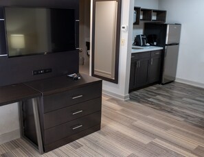A modern kitchen with a built-in refrigerator, a coffee maker, and a microwave. - Holiday Inn Express Hotel & Suites Conover (Hickory Area) by IHG (Conover)