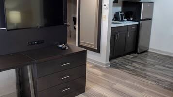 A modern kitchen with a built-in refrigerator, a microwave, and a coffee maker.