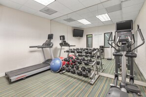 A gym with treadmills, a stationary bike, a rowing machine, and a rack of dumbbells. - Holiday Inn Express & Suites Tacoma by IHG (Tacoma)