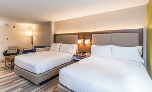 Une chambre d’hôtel avec deux lits, une table de chevet, une lampe et une horloge.