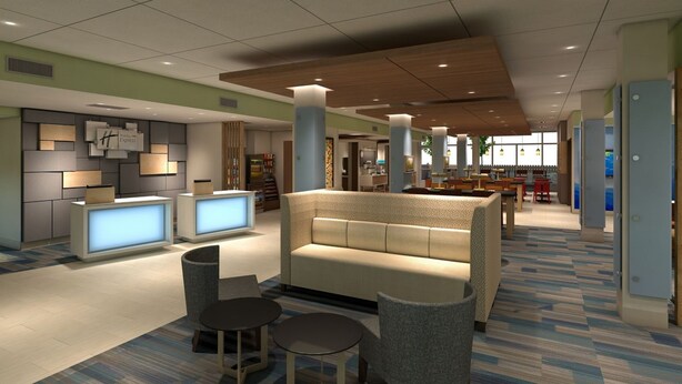 A modern lobby with a reception desk, seating area, and a dining space.