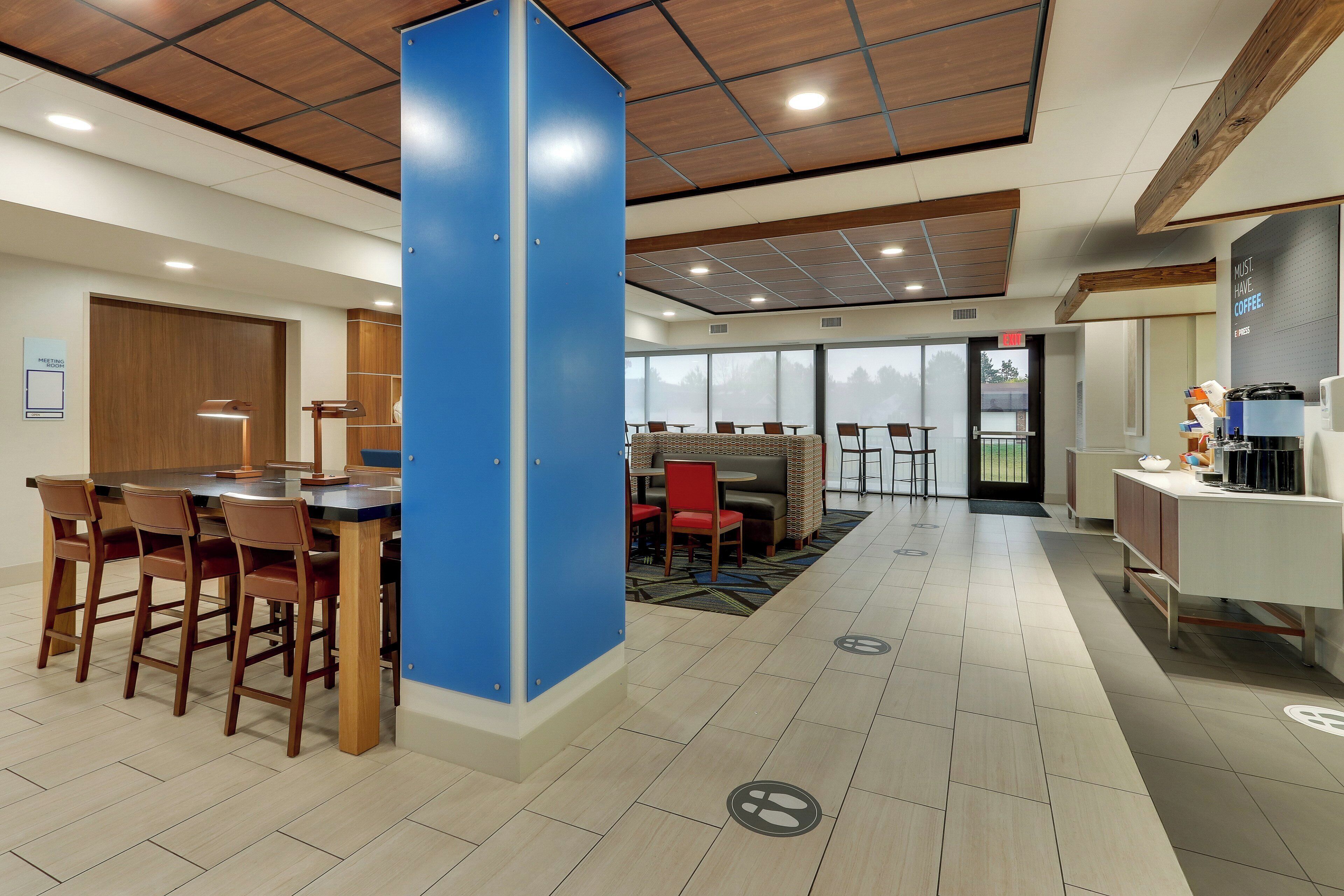 A modern interior with a bar area, seating, and a large blue partition.